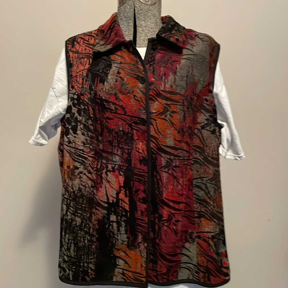 Vest, reversible. Multicolored/black. No tags. Excellent condition.